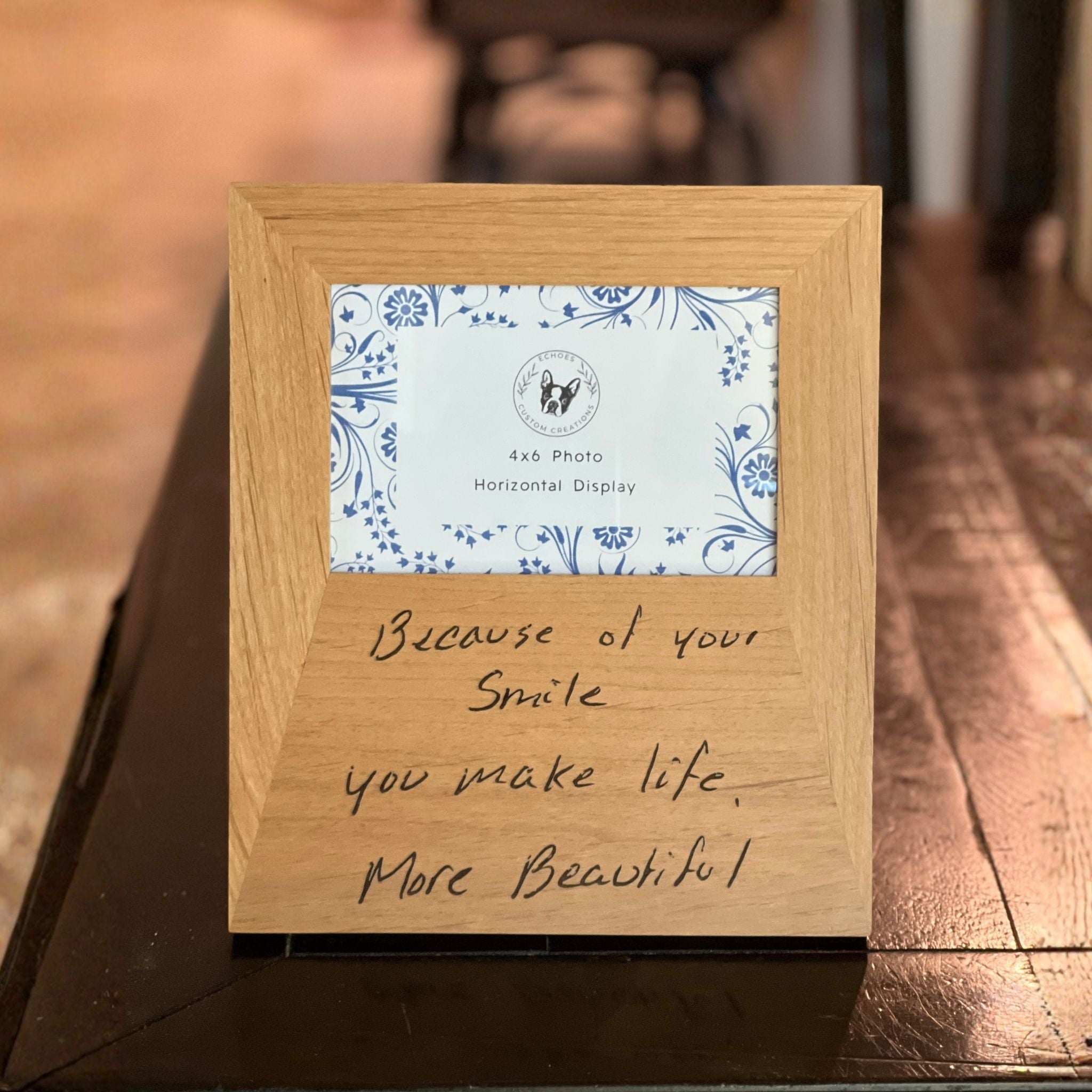 Wooden photo frame engraved with a handwritten message and decorative card stating it accommodates a 4x6 photo.