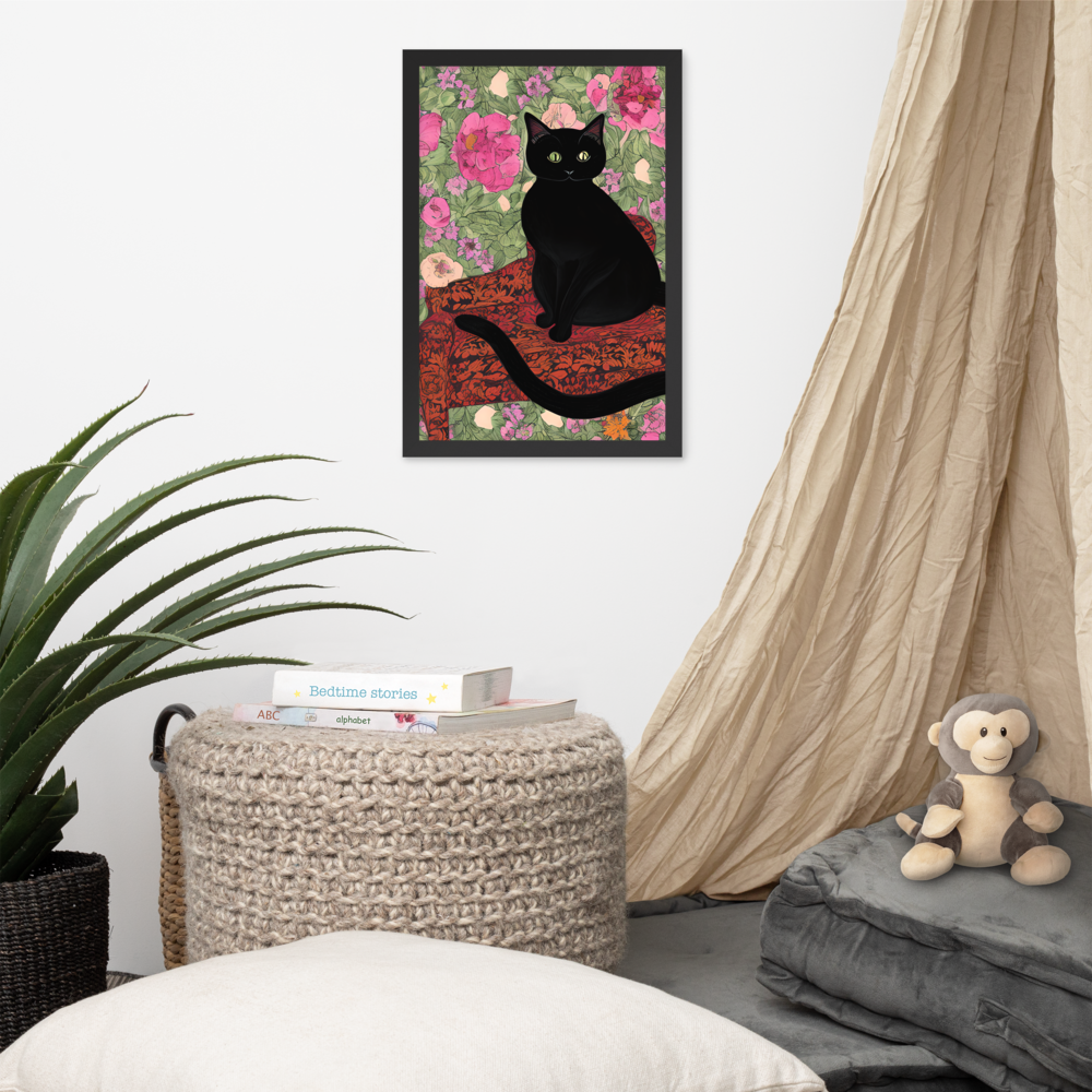 Framed artwork of a black cat on a floral background in a room with a plant, ottoman, and monkey plush toy.